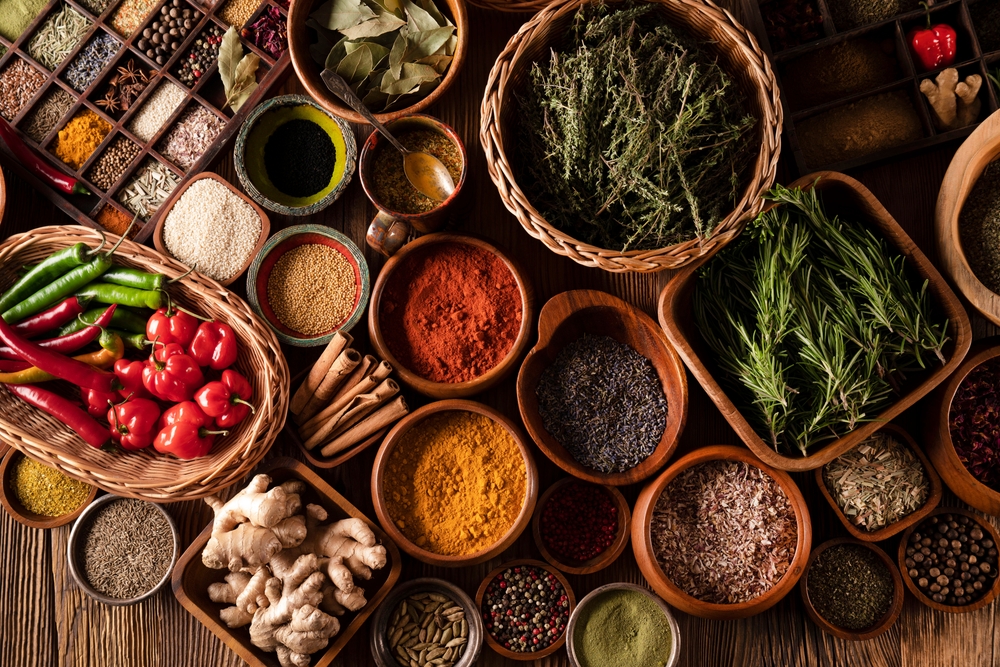 a variety of spices on wooden table